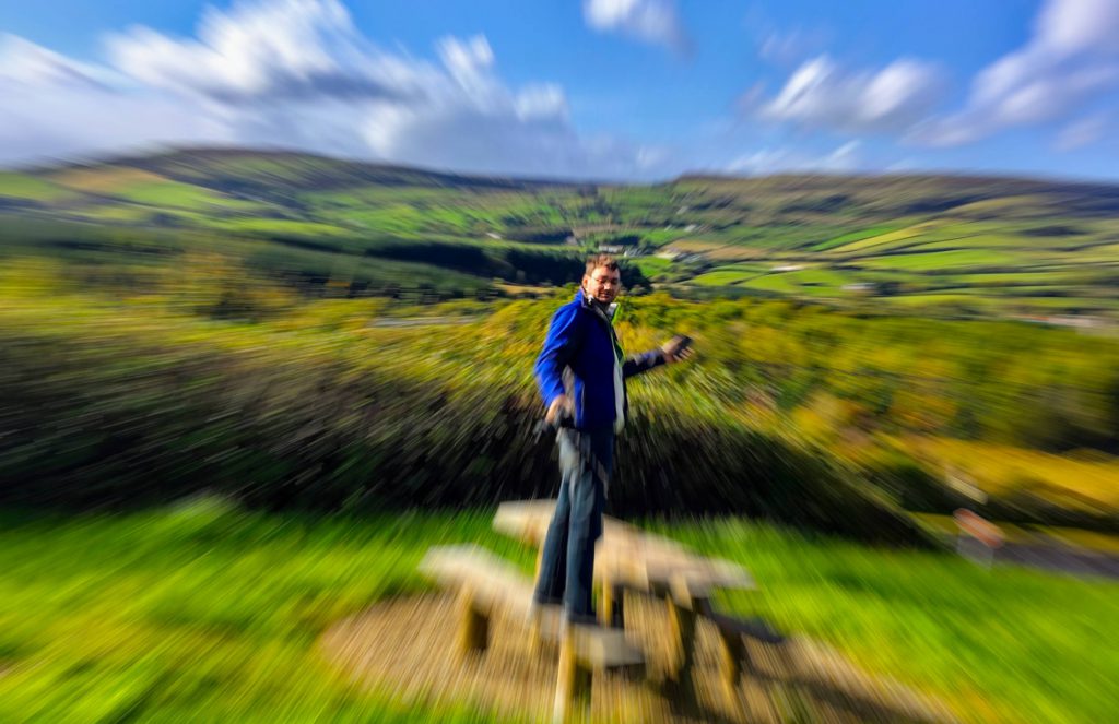 Picture of me in Ireland standing on a picnic bench