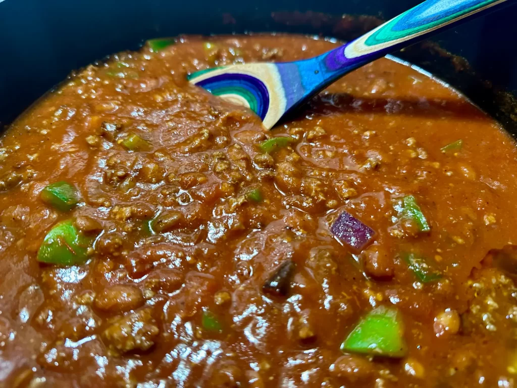 Bowl of Chili with a spoon in the pot